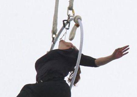 Erendira Wallenda hangs onto an aerial loop by her teeth over a waterfall.